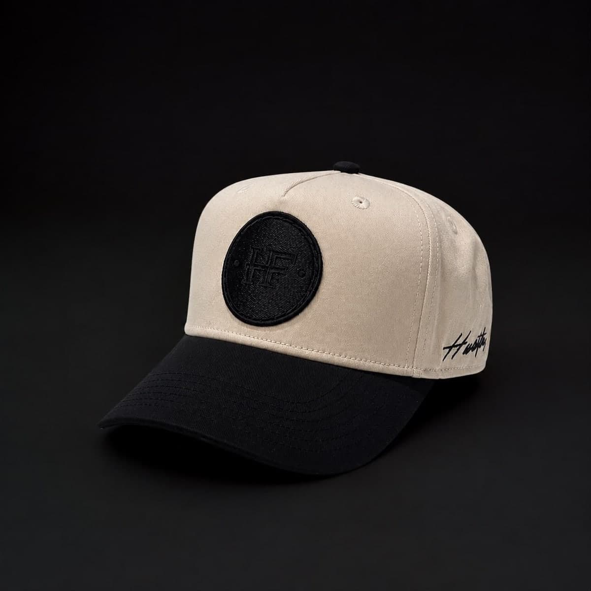three-quarter view showing the black brim and tonal HF patch